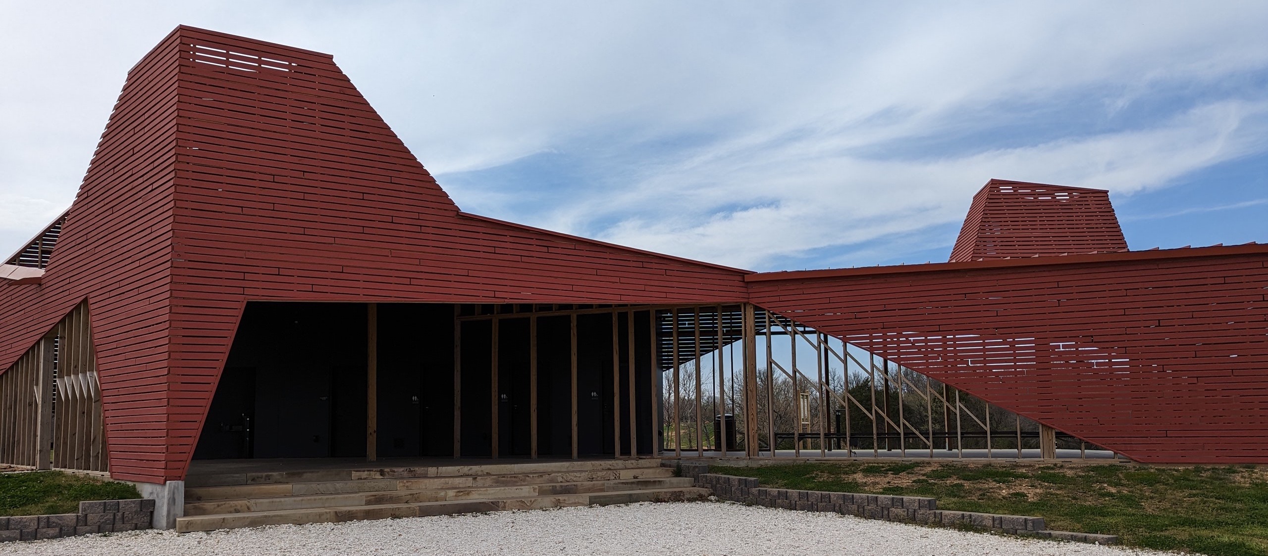 A giant unique building that features unique angled architecture that serves as the hub for Centennial Park.