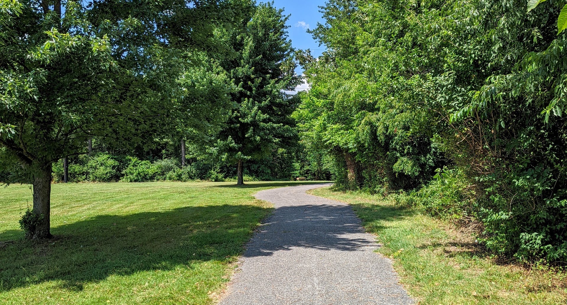 One of the many paved paths that run along the disc golf course that is shared with the connected JB Hunt park.